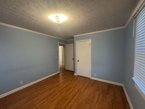 a view of a room with wooden floor