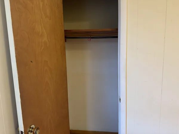 a view of a yard with wooden fence