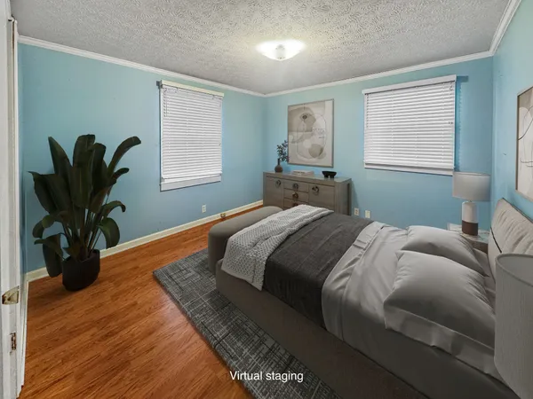 a bed sitting in a bedroom next to a large window