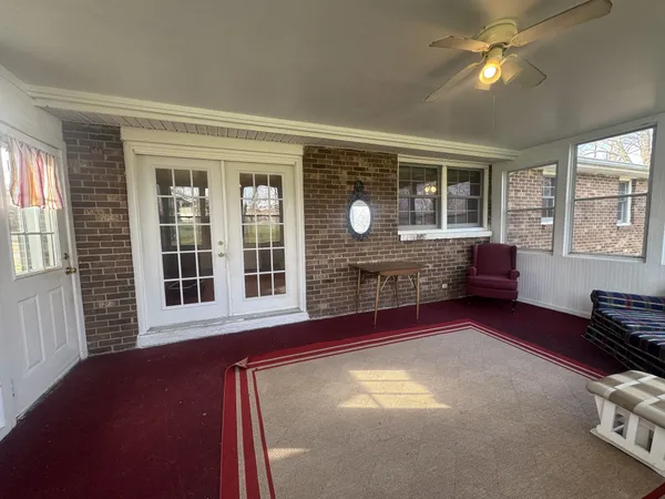 a view of empty room with wooden floor and fireplace