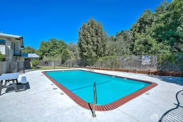 a view of a swimming pool with a patio