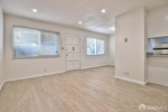 an empty room with windows and closet