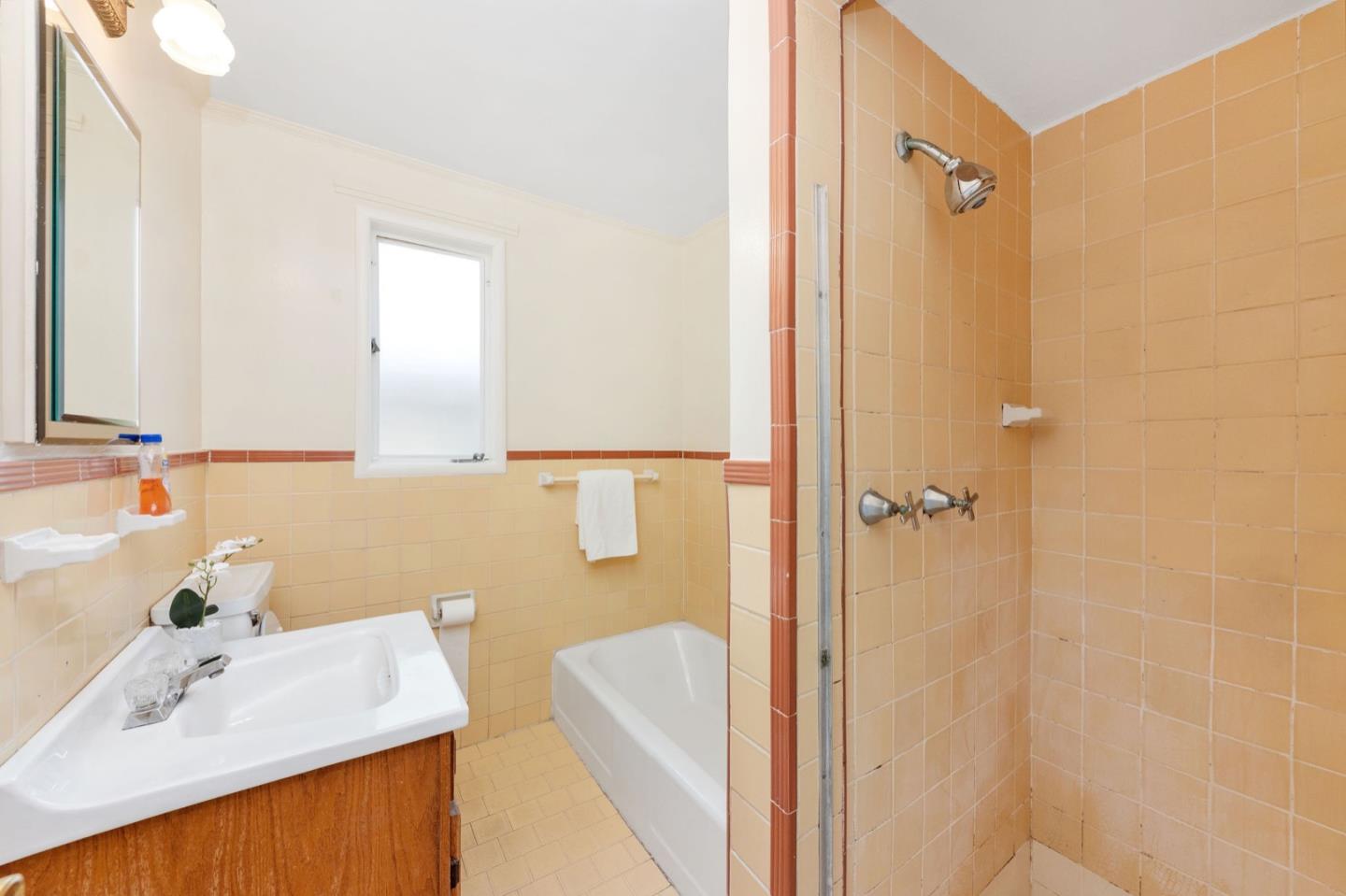 224 Helen Drive Millbrae, CA 94030 - Photo 25 of 42 a bathroom with a sink a tub and a mirror