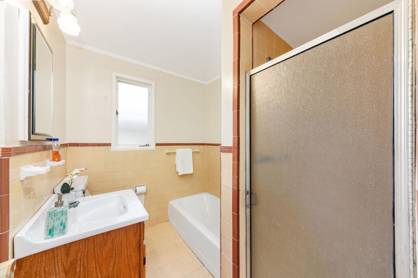 224 Helen Drive Millbrae, CA 94030 - Photo 26 of 42 a bathroom with a sink a mirror and a shower
