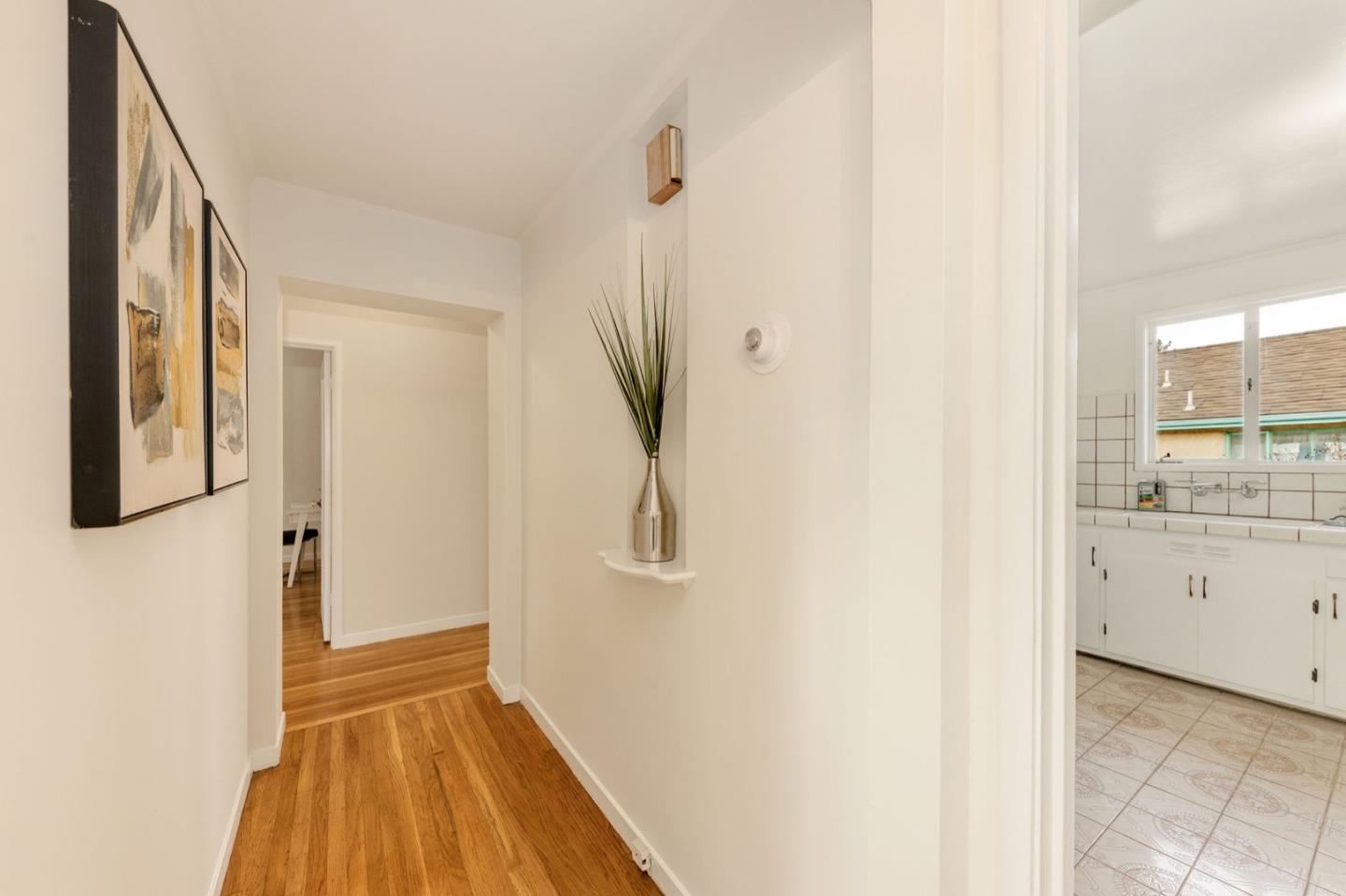 224 Helen Drive Millbrae, CA 94030 - Photo 27 of 42 a view of a hallway with wooden floor and cabinet