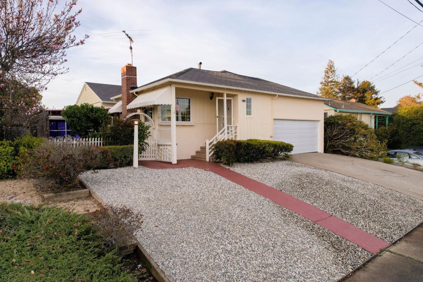 224 Helen Drive Millbrae, CA 94030 - Photo 6 of 42 a front view of a house with a yard and garage
