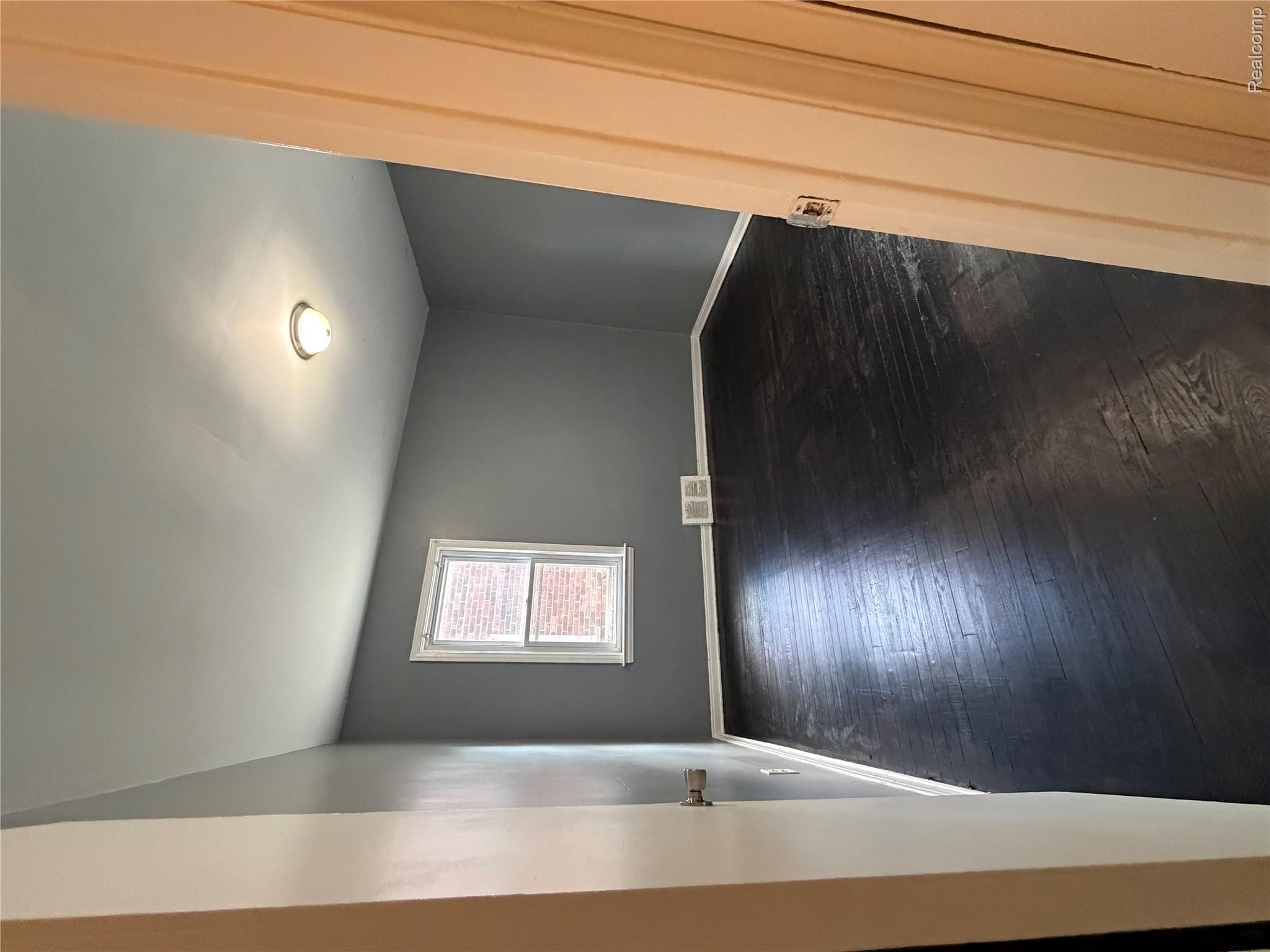 7633 Fielding Street Detroit, MI 48228 - Photo 8 of 12 Room with dark wood-finish flooring, white baseboards, and neutral grey walls