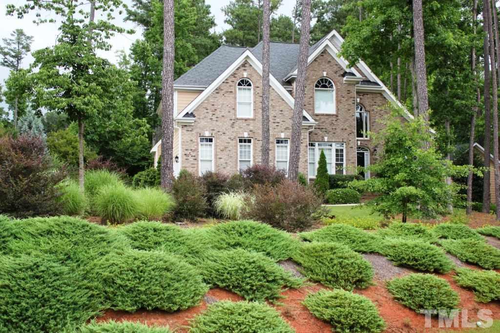 7217 Duncans Ridge Way Fuquay-Varina, NC 27526 - Photo 1 of 25 a view of a big house with a big yard and large trees