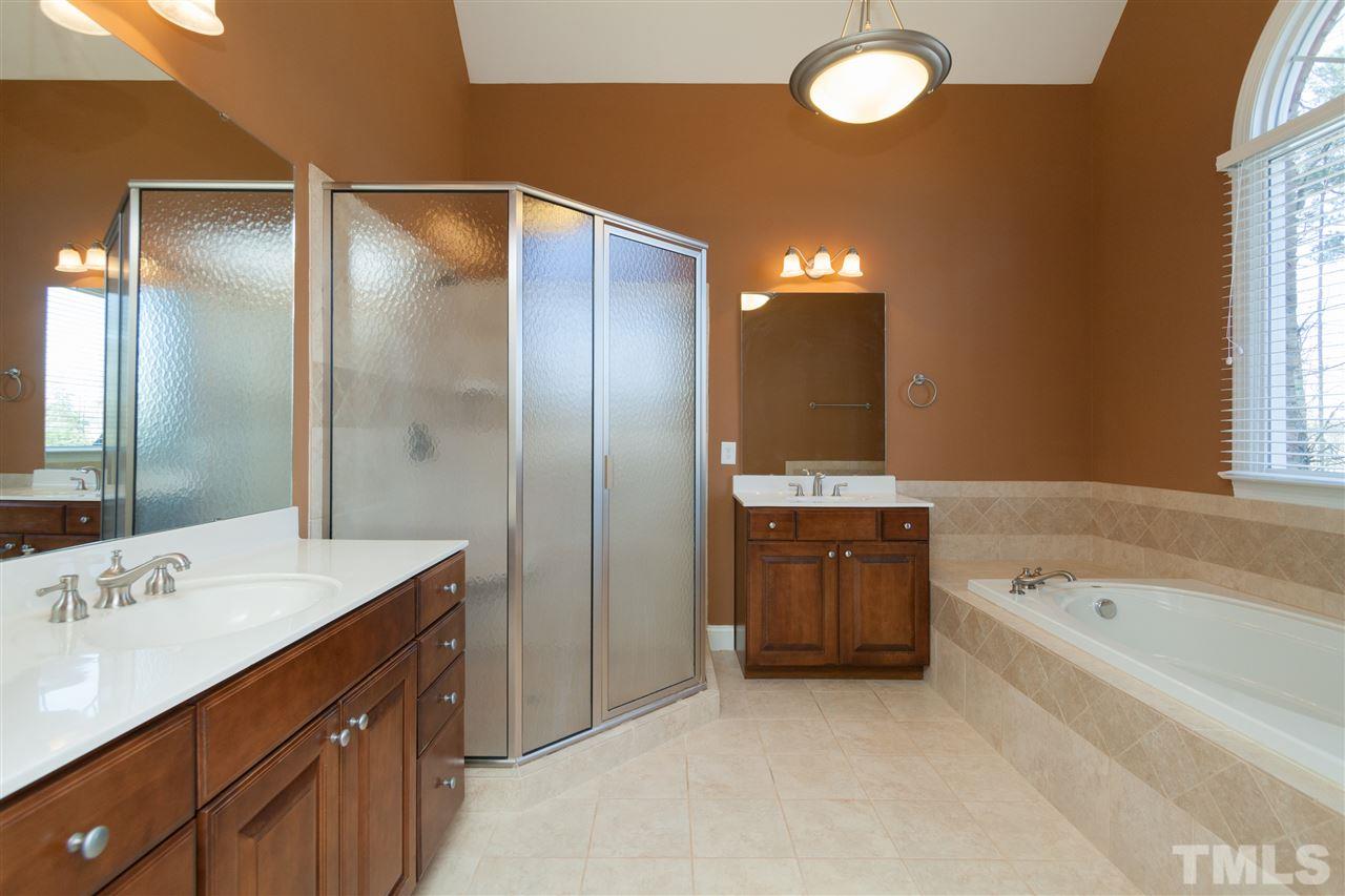 7217 Duncans Ridge Way Fuquay-Varina, NC 27526 - Photo 11 of 25 a bathroom with a sink double vanity and a bathtub