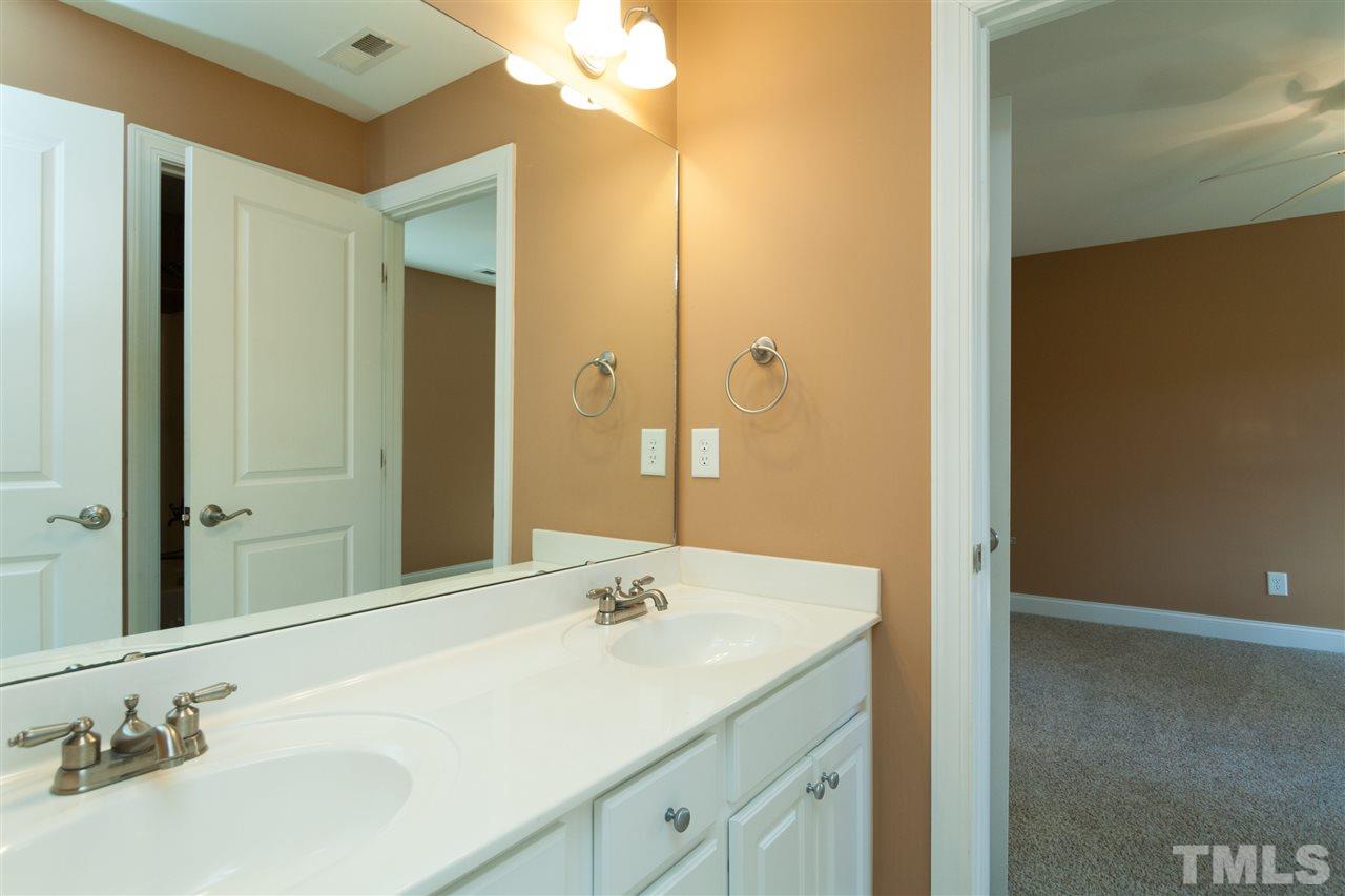 7217 Duncans Ridge Way Fuquay-Varina, NC 27526 - Photo 14 of 25 a bathroom with a sink and a mirror