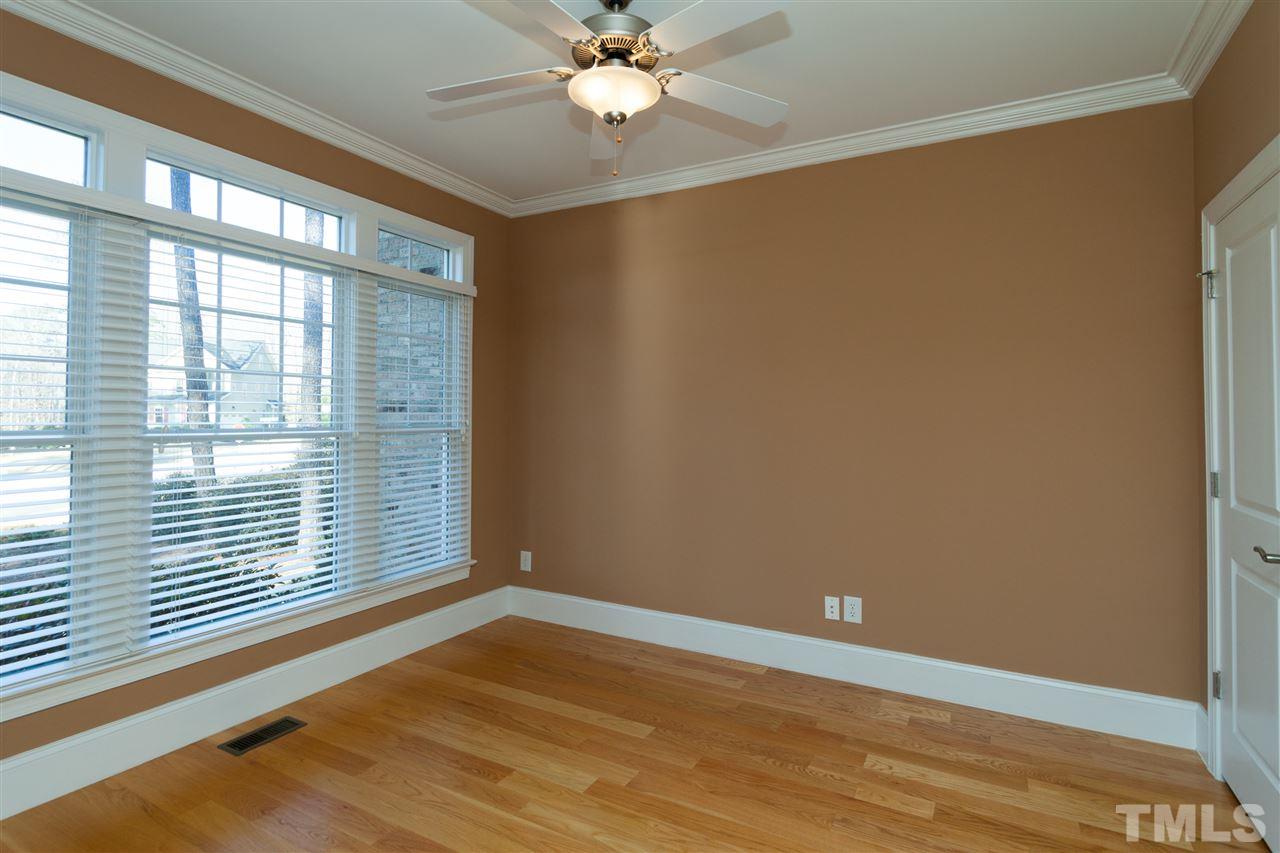 7217 Duncans Ridge Way Fuquay-Varina, NC 27526 - Photo 15 of 25 a view of an empty room with a window and wooden floor
