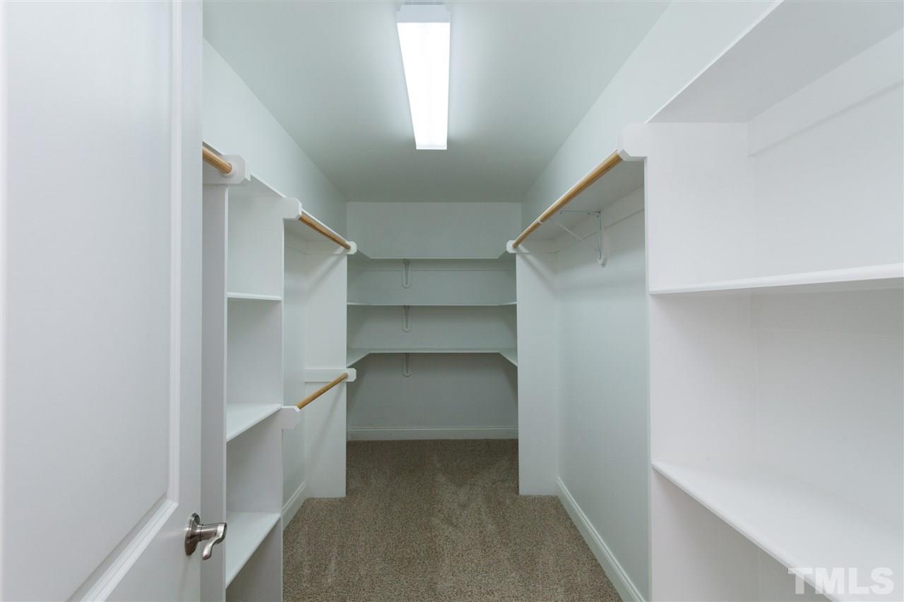 7217 Duncans Ridge Way Fuquay-Varina, NC 27526 - Photo 20 of 25 a view of walk in closet with empty racks