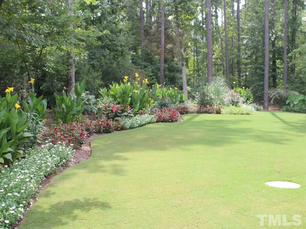 7217 Duncans Ridge Way Fuquay-Varina, NC 27526 - Photo 25 of 25 a view of a garden with plants and large trees