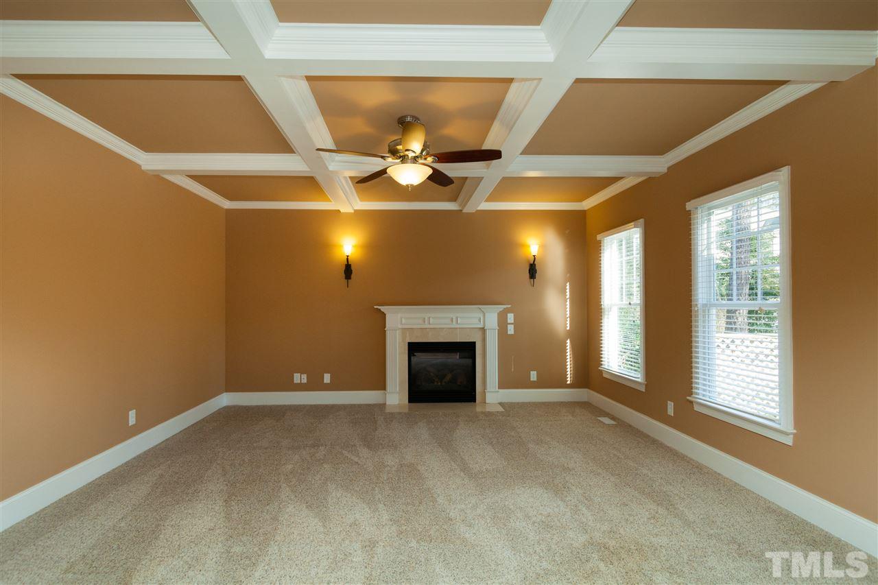 7217 Duncans Ridge Way Fuquay-Varina, NC 27526 - Photo 7 of 25 a view of an empty room with a fireplace and a window