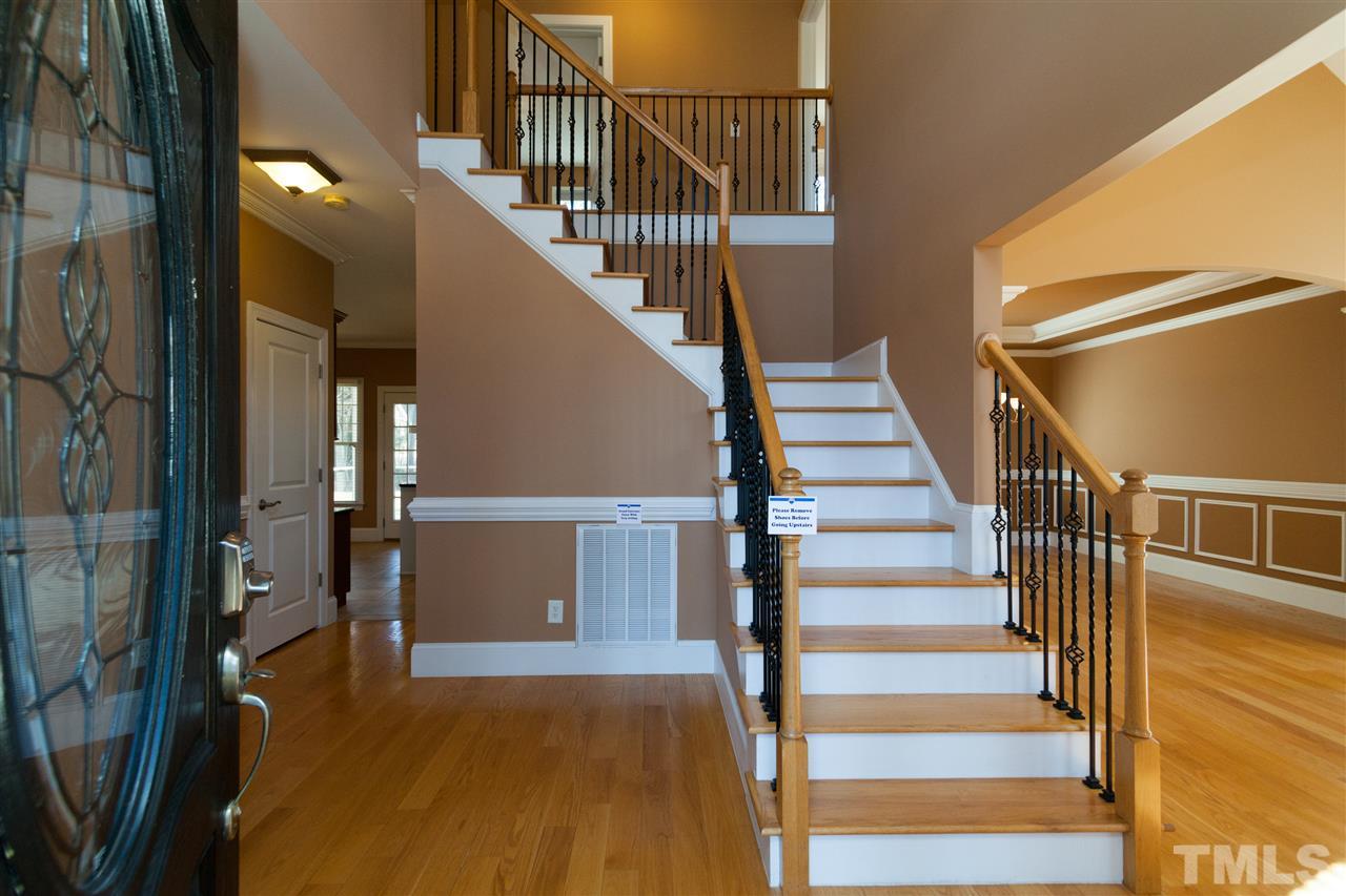 7217 Duncans Ridge Way Fuquay-Varina, NC 27526 - Photo 8 of 25 a view of entryway and hall with wooden floor