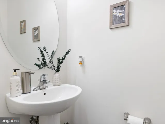 a bathroom with a sink a mirror and vanity