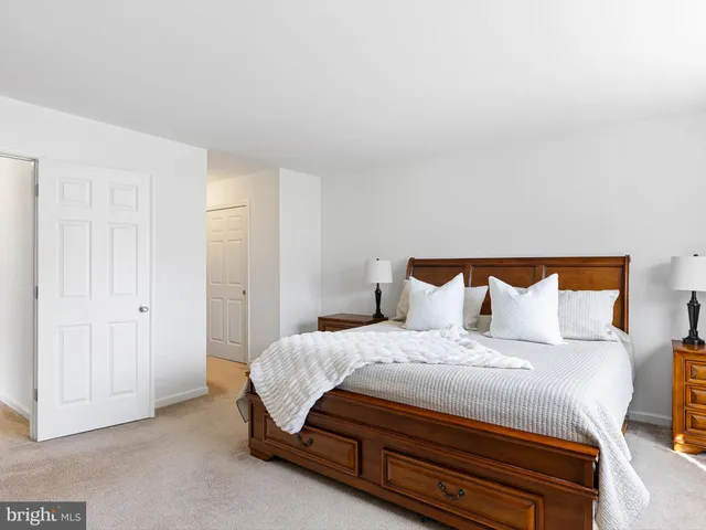 a bedroom with a bed and mirror