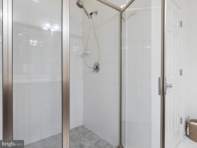 a bathroom with a glass shower door