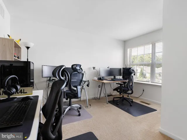 a view of a workspace with furniture and a window