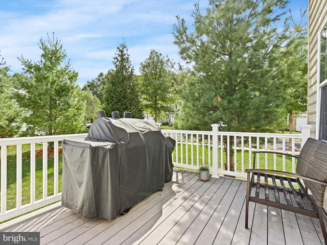 a balcony with wooden floor table and chairs