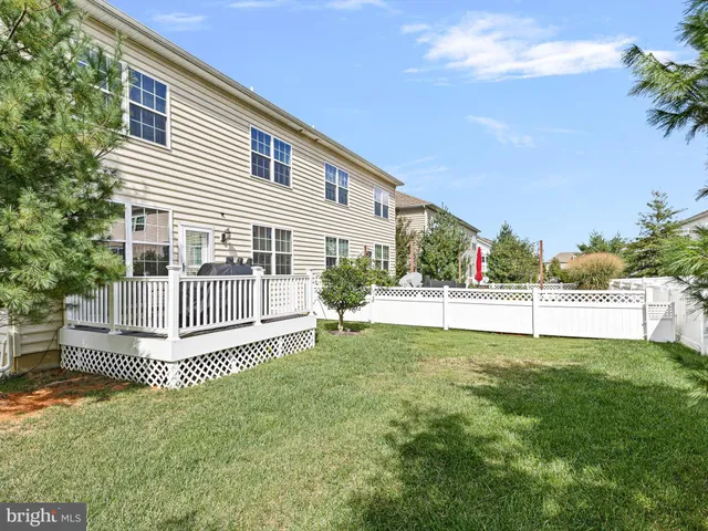 a view of a house with a yard and a garden