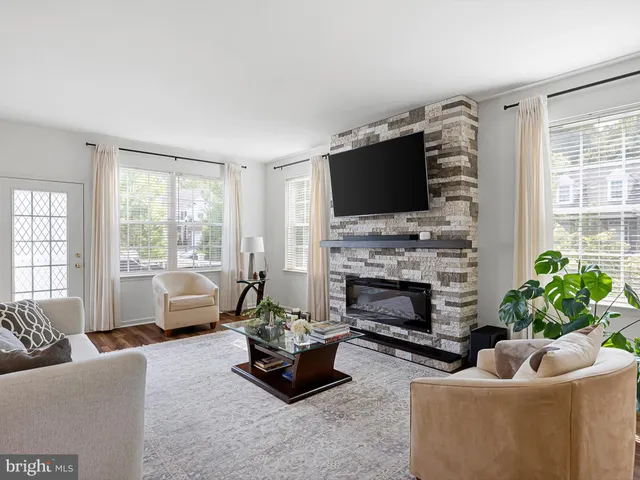 a living room with furniture flat screen tv and a fireplace