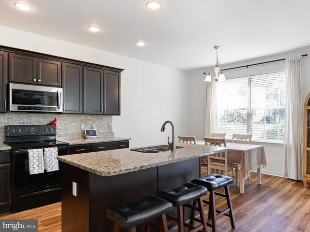 a kitchen with a stove a sink and a refrigerator