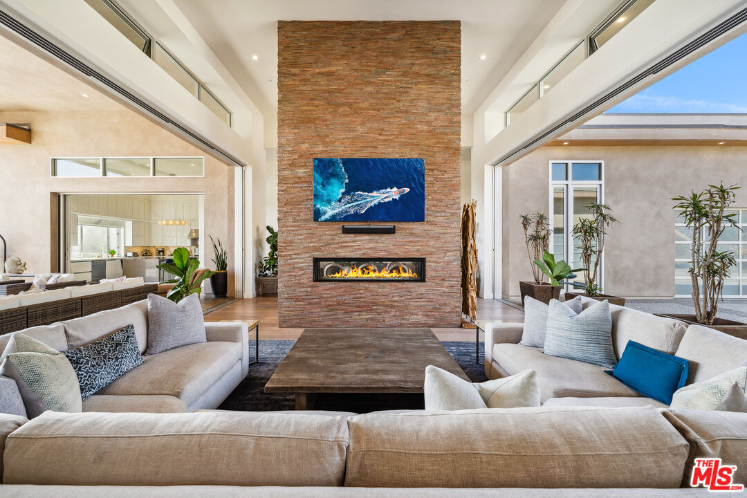 10715 Yerba Buena Road Malibu, CA 90265 - Photo 12 of 32 a living room with furniture and a fireplace