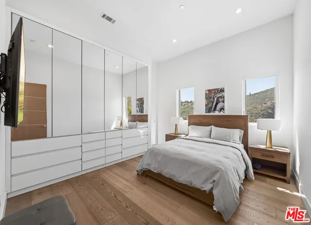 a bedroom with a large bed and a window