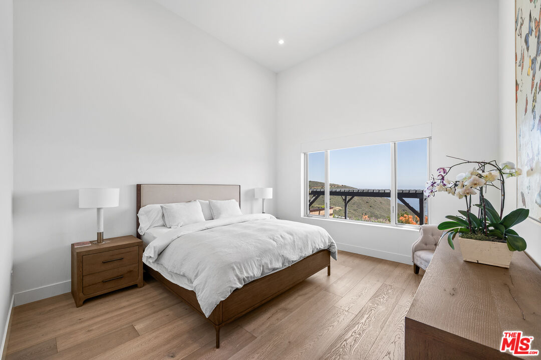 10715 Yerba Buena Road Malibu, CA 90265 - Photo 19 of 32 a spacious bedroom with a bed and a couch