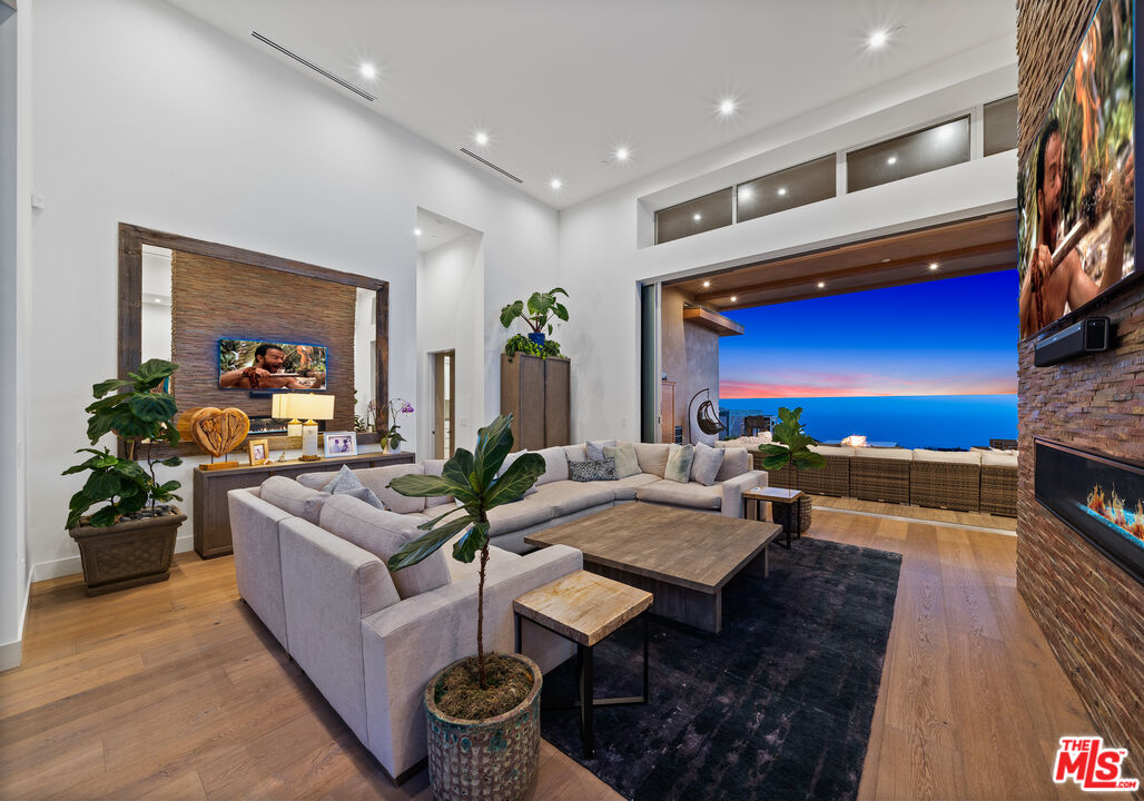 10715 Yerba Buena Road Malibu, CA 90265 - Photo 21 of 32 a living room with furniture and a fireplace