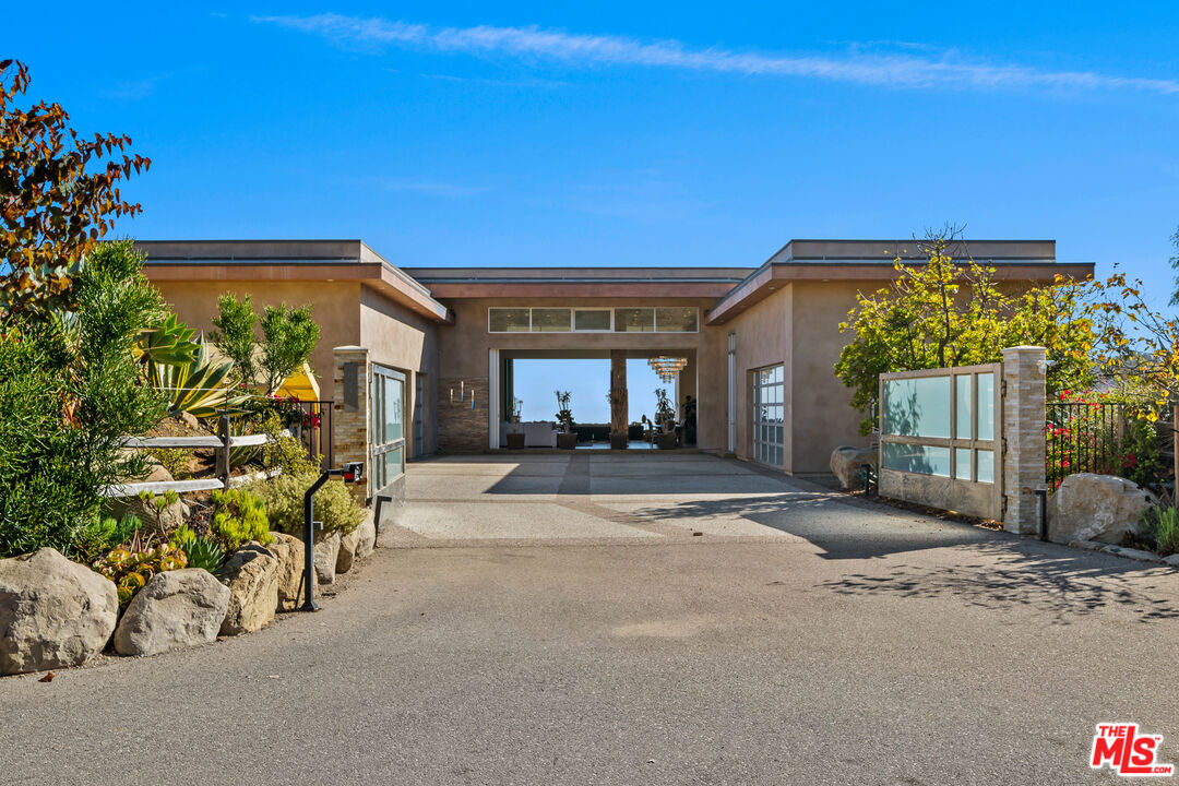 10715 Yerba Buena Road Malibu, CA 90265 - Photo 25 of 32 a view of a house with a patio