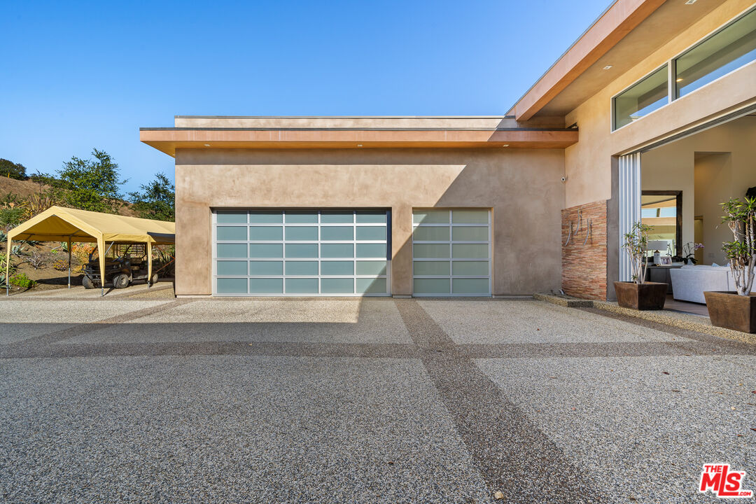 10715 Yerba Buena Road Malibu, CA 90265 - Photo 26 of 32 a front view of a house with a yard