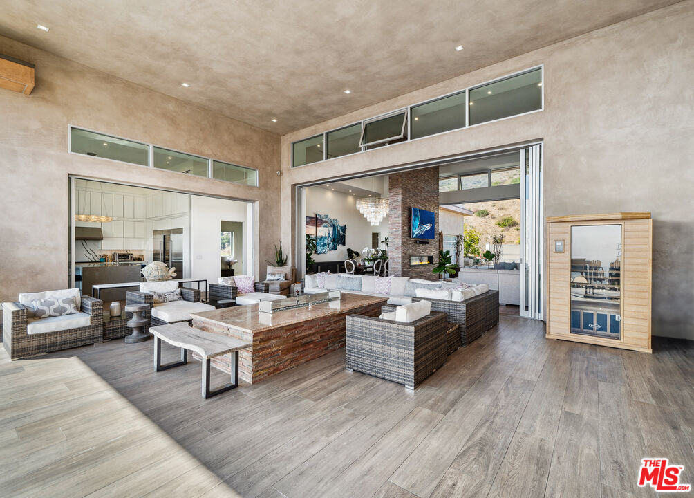 10715 Yerba Buena Road Malibu, CA 90265 - Photo 31 of 32 a living room with furniture and a wooden floor