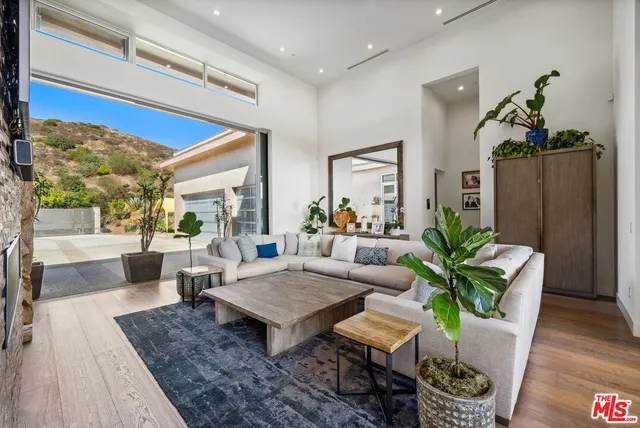 a living room with furniture rug and wooden floor