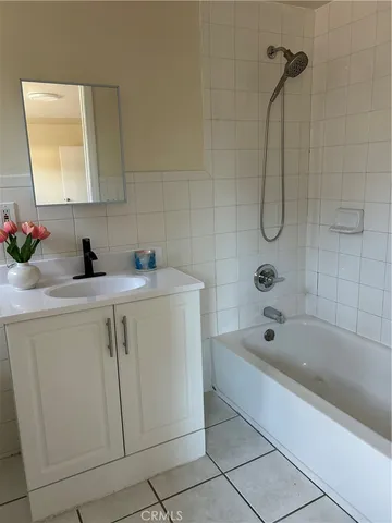 a bathroom with a sink a mirror and a bathtub