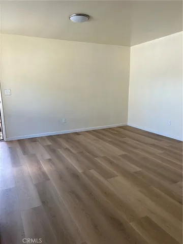 an empty room with wooden floor