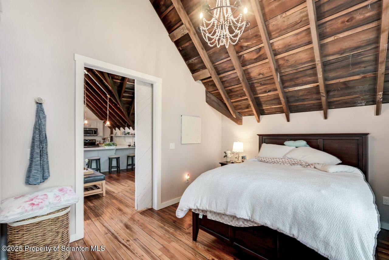 215 Fairview Road Clarks Green, PA 18411 - Photo 126 of 148 a bedroom with a bed a flat screen tv and a book shelf