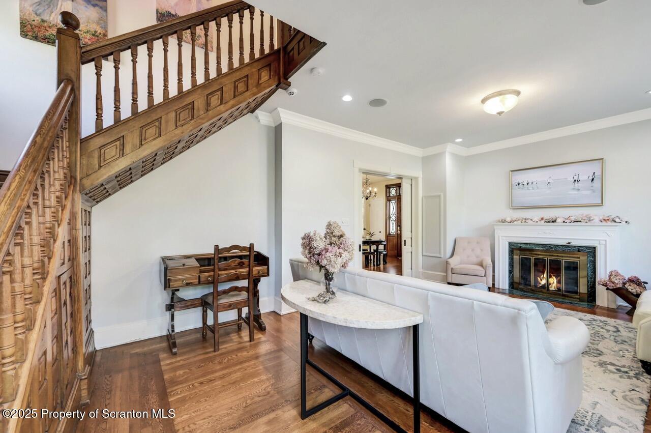 215 Fairview Road Clarks Green, PA 18411 - Photo 18 of 148 a living room with furniture a fireplace and a dining table with wooden floor