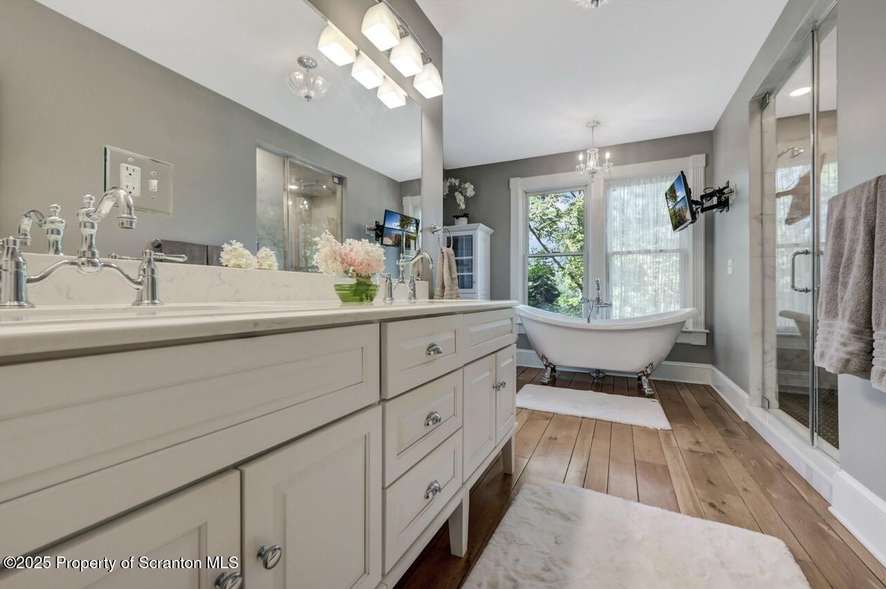 215 Fairview Road Clarks Green, PA 18411 - Photo 47 of 148 a spacious bathroom with a double vanity sink a mirror a bathtub and a window