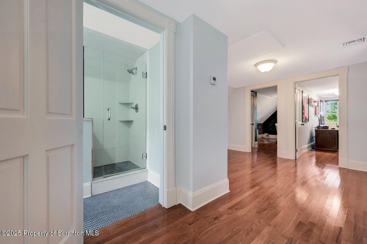 215 Fairview Road Clarks Green, PA 18411 - Photo 61 of 148 a view of an empty room with wooden floor and a bathroom