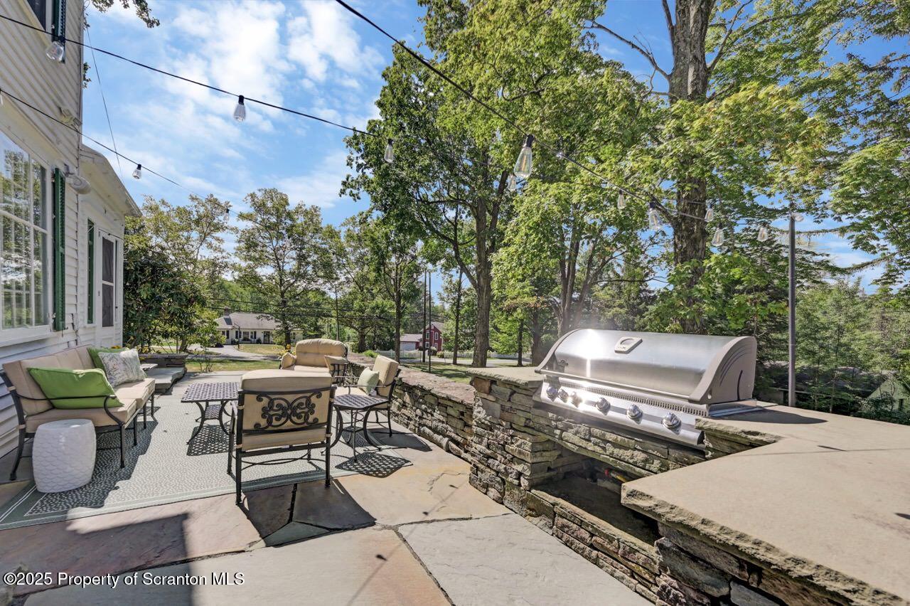 215 Fairview Road Clarks Green, PA 18411 - Photo 82 of 148 a view of a patio with a dining table and chairs with a small yard