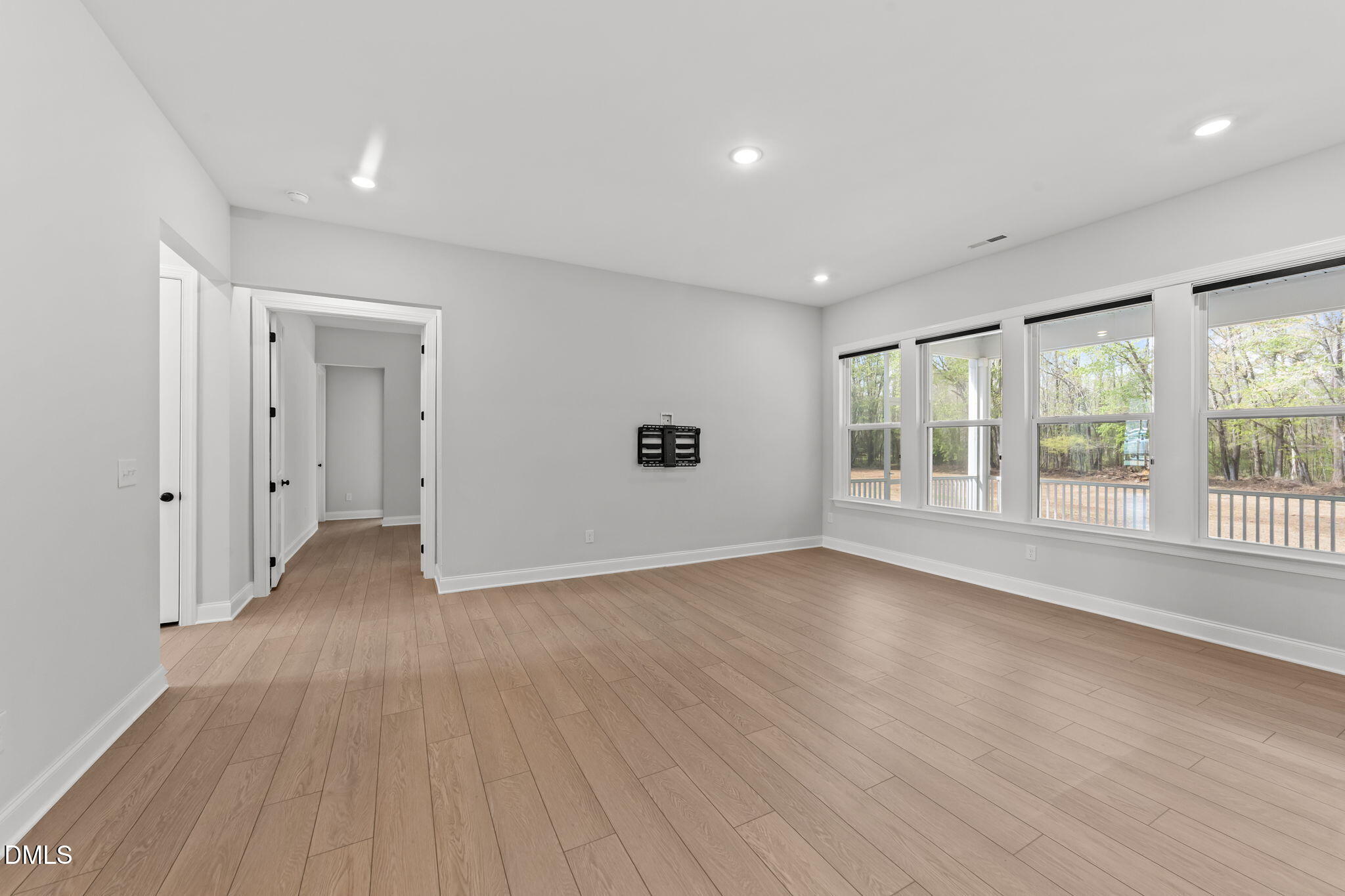 188 Flight Pattern Way Garner, NC 27529 - Photo 25 of 41 a view of an empty room with wooden floor and a window