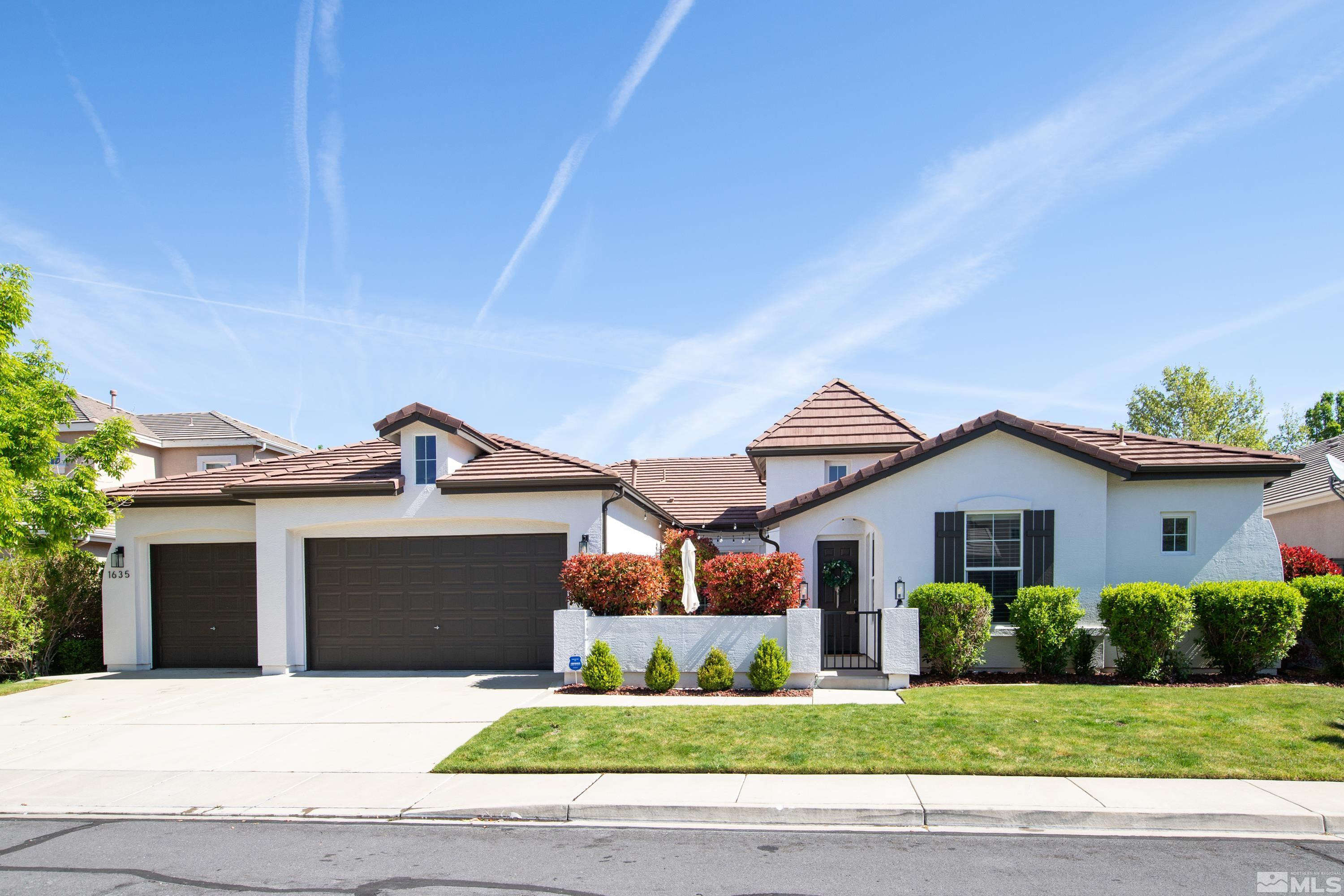 1635 Trailhead Drive Reno, NV 89521 - Photo 1 of 39 a front view of a house with a yard and garage