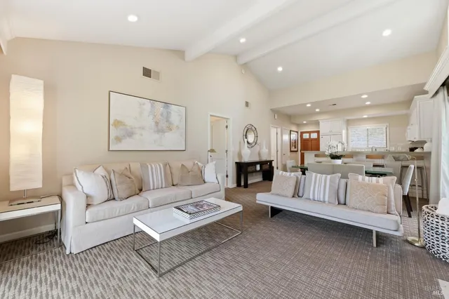 a view of a roof deck with a table and chairs under an umbrella with a small yard