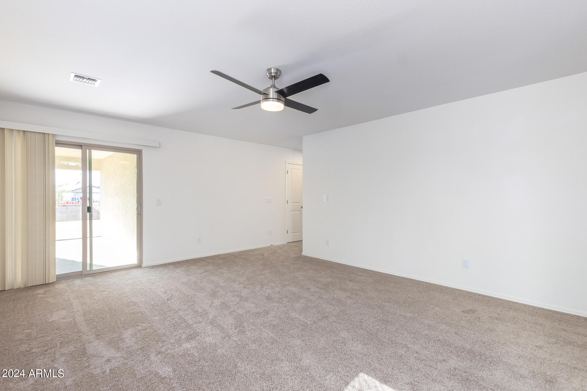 1832 South Hayley Road Apache Junction, AZ 85119 - Photo 12 of 30 an empty room with a ceiling fan and a window