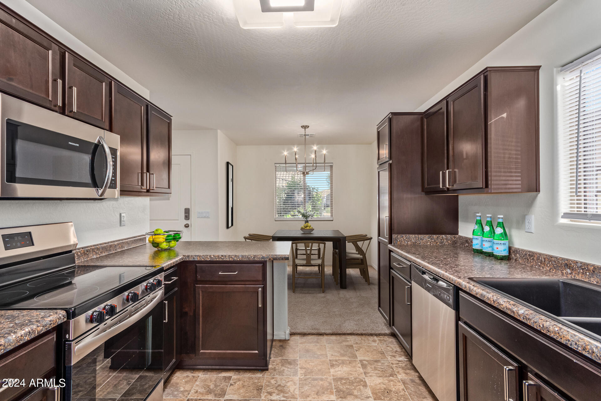 1832 South Hayley Road Apache Junction, AZ 85119 - Photo 5 of 30 a kitchen with stainless steel appliances a stove a sink dishwasher a microwave oven with granite countertops and cabinets