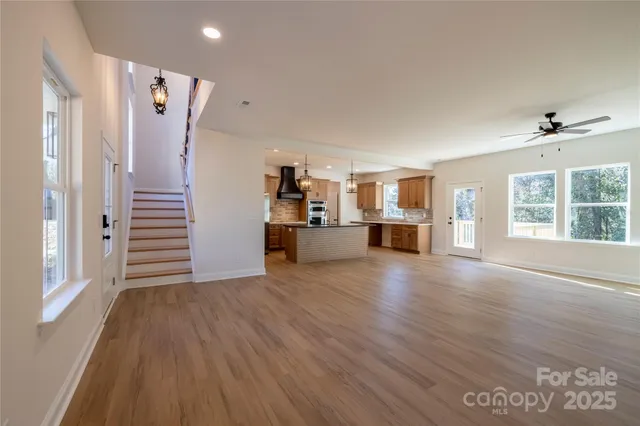 a view of a kitchen with furniture and wooden floor