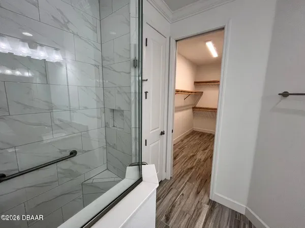 a bathroom with double vanity and a shower