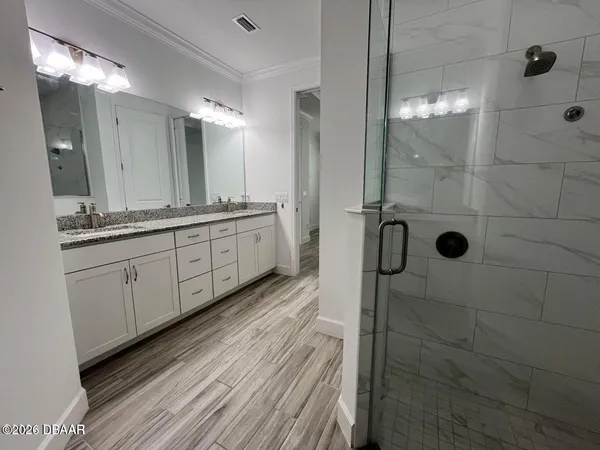 a bedroom with a bed next to a window